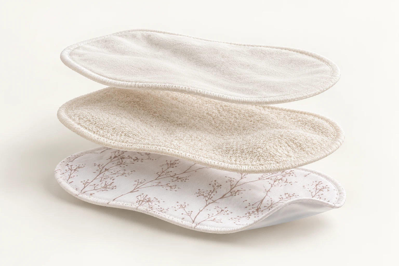 Three-layer breast pad structure: contact fleece, bamboo terry core and waterproof printed backing