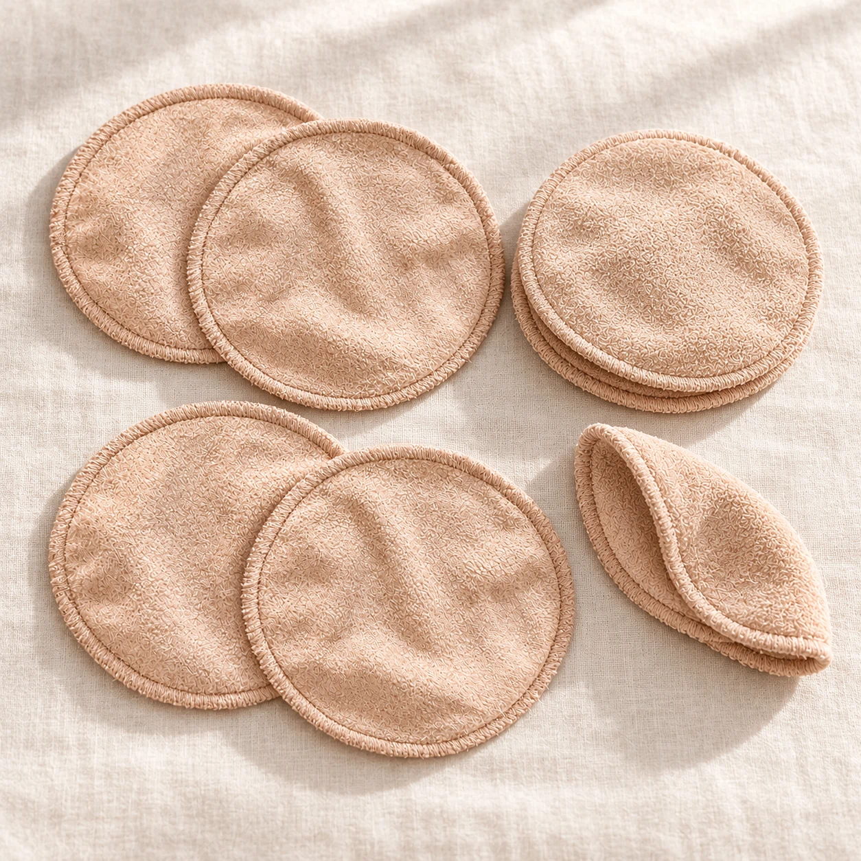 Reusable bamboo charcoal breast pads shown as a soft multi-pack set
