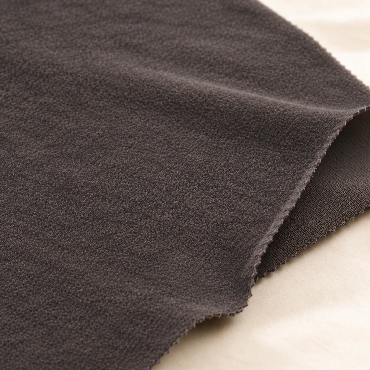 Close-up of the soft bamboo charcoal fleece surface of a reusable breast pad